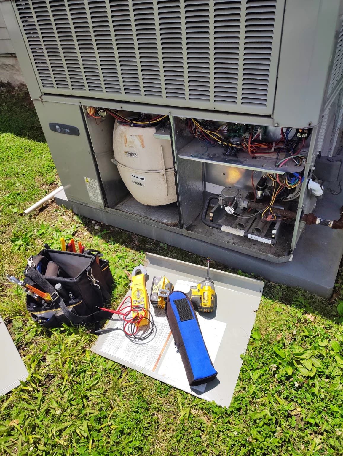 Packaged HVAC equipment opened with field tools ready for testing