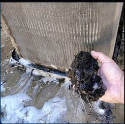 Dirty condenser coil before cleaning during Civive Air Services AC work